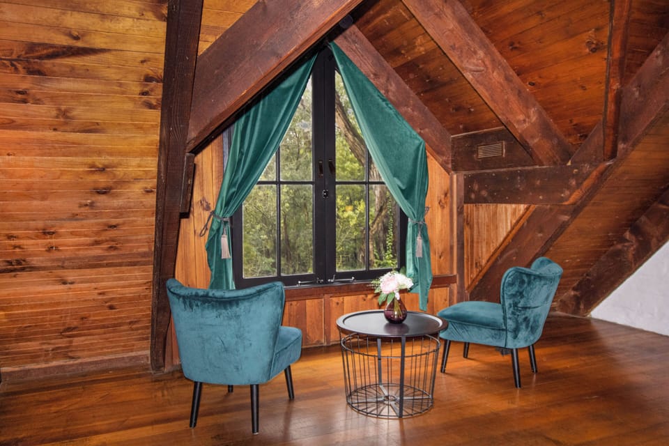 Cozy loft seating nook with forest views and rustic timber charm