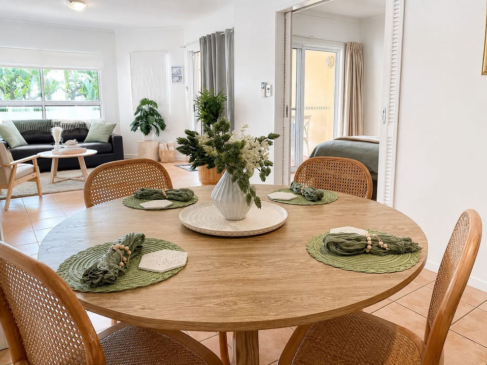 Bright open-plan dining and living space with stylish natural décor