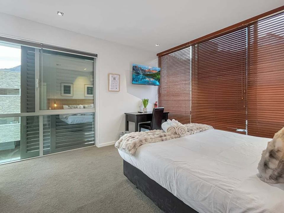 Light-filled bedroom with private alpine outlooks.