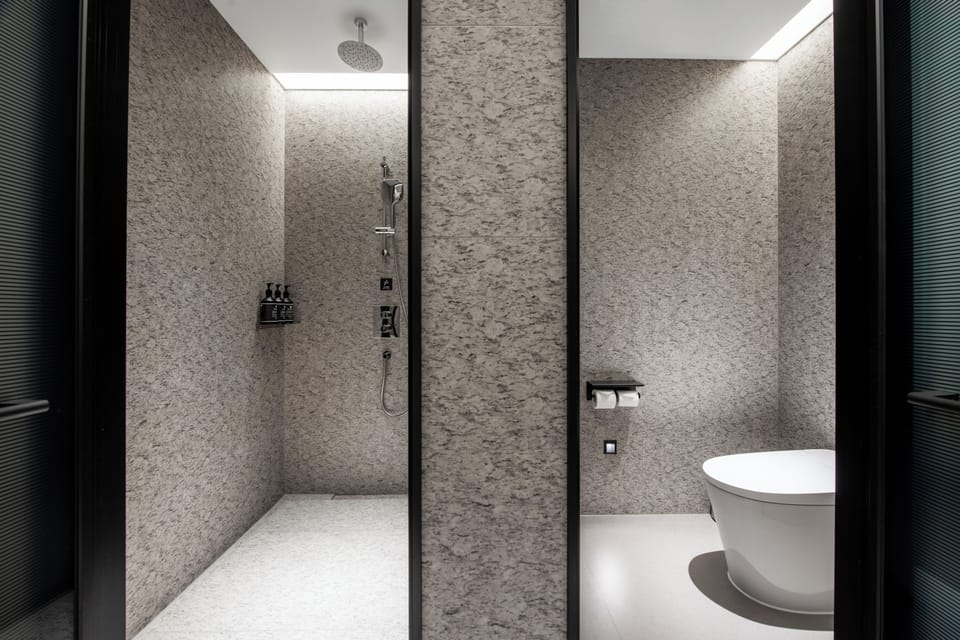Luxury Suite, City View | Bathroom | Shower, hair dryer, slippers, towels
