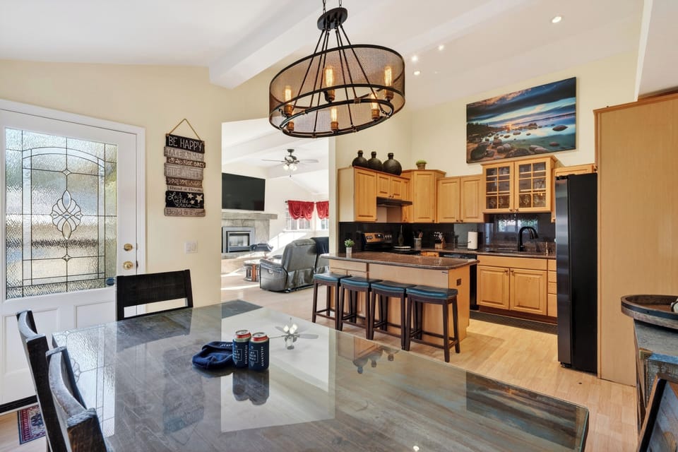 Open dining and kitchen space with bar seating, warm lighting, and easy flow into the living room. 