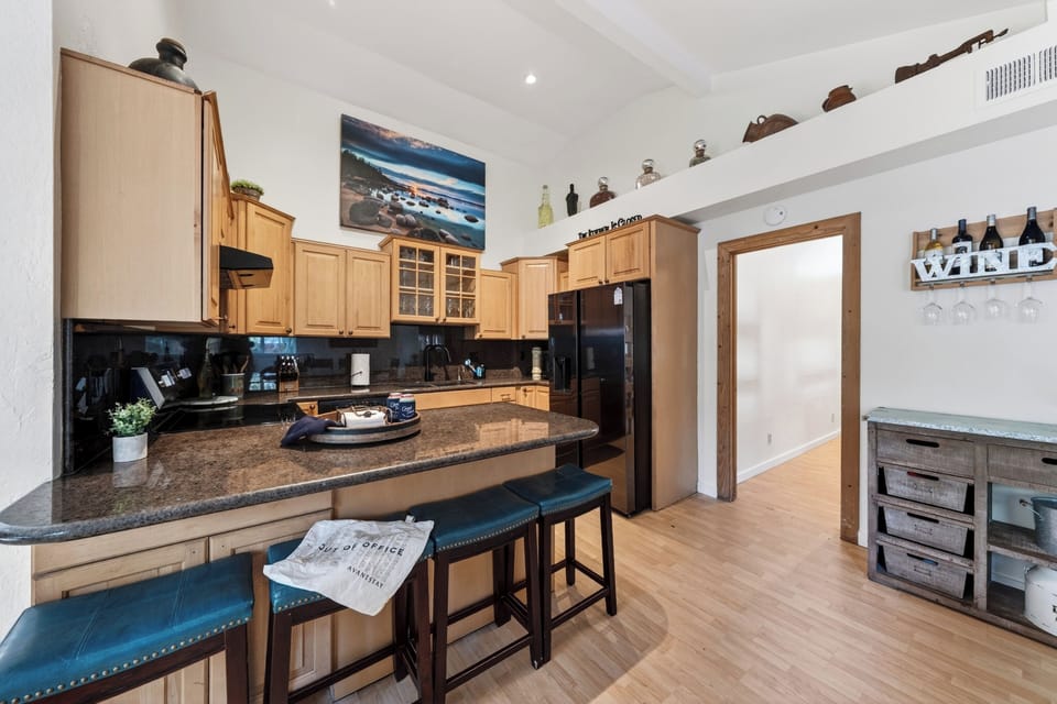 Fully equipped kitchen with island seating and easy flow into the main living area. 