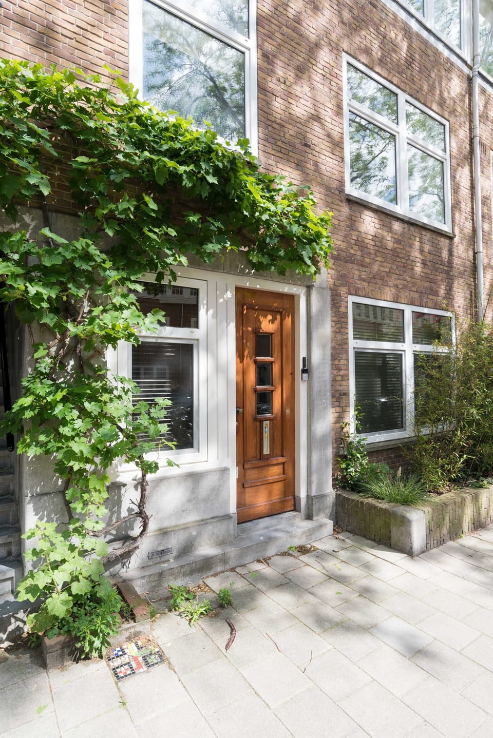 Step outside into a picturesque Amsterdam street lined with greenery and characterful façades.