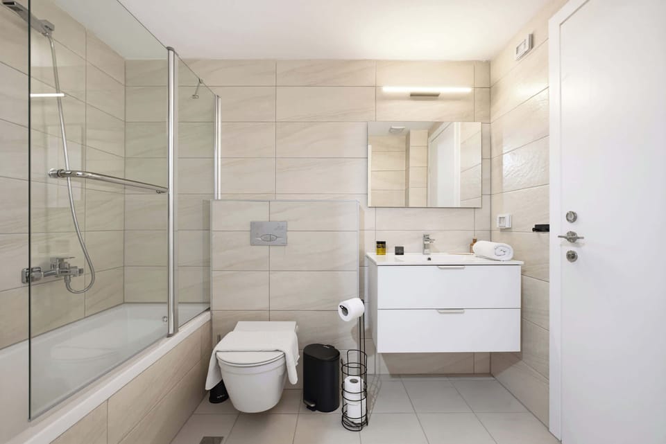 Indulge in a rejuvenating bath or a warm shower after exploring local attractions throughout this beautifully tiled, modern bathroom suite.