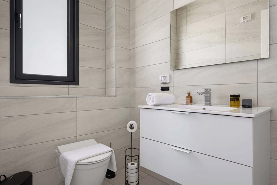 A bright, clean vanity with dual drawer storage provides an organized and refreshing space to prepare for the day ahead.