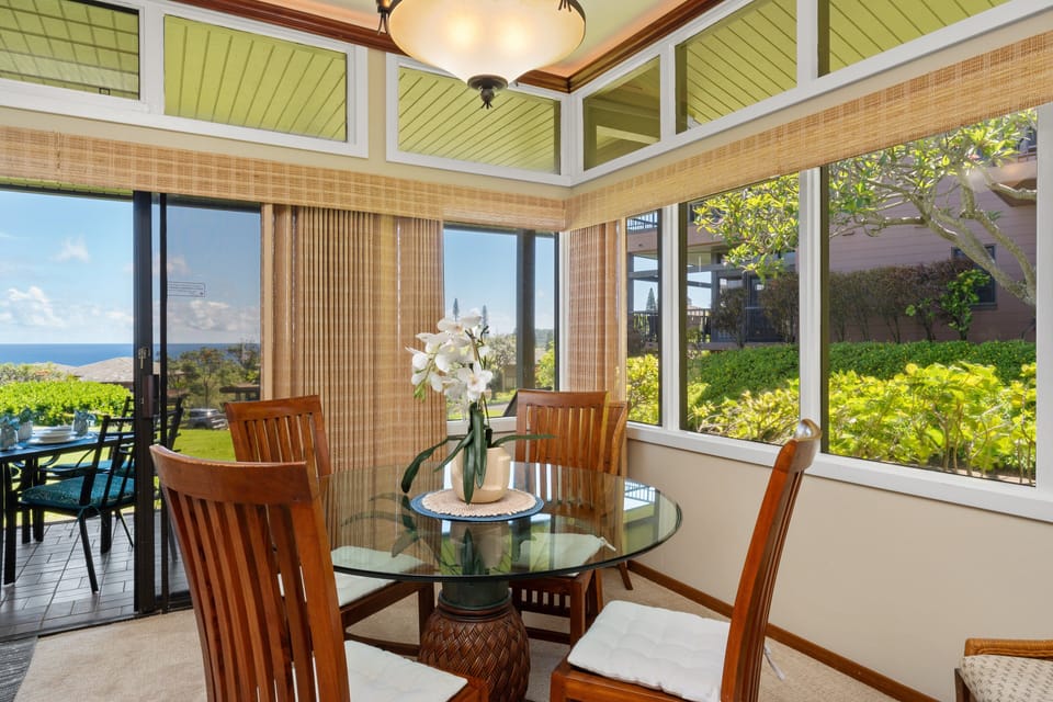 Cozy dining area framed by windows, perfect for enjoying meals with views of the landscaped grounds.