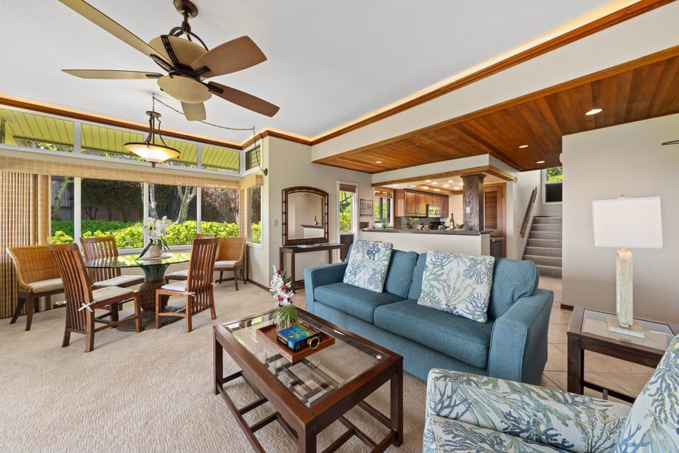 Spacious interior with comfortable seating, dining area, and seamless access to the outdoor patio and coastal views.