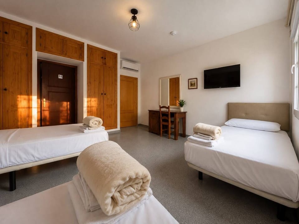 Standard Triple Room, Courtyard View | Desk, laptop workspace, WiFi (free), bed sheets