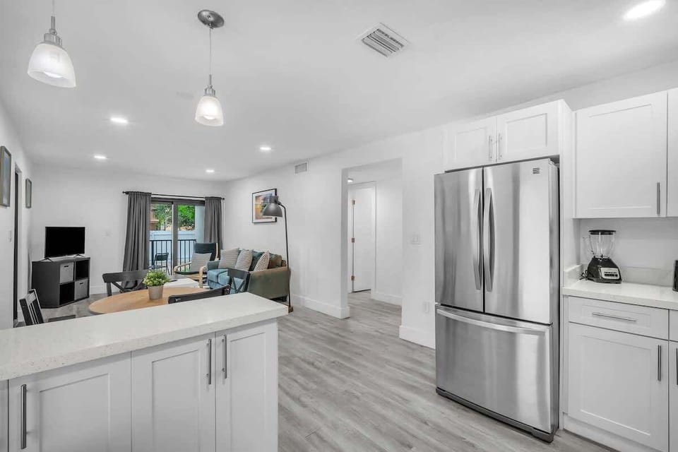 A sleek, clutter-free kitchen with all the necessary amenities, including a spacious refrigerator, dishwasher, and essential cooking tools.