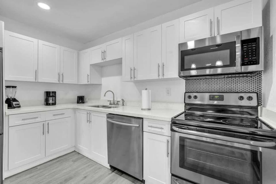 Updated kitchen featuring stainless-steel appliances, bright cabinetry, and everything needed for cooking at home.