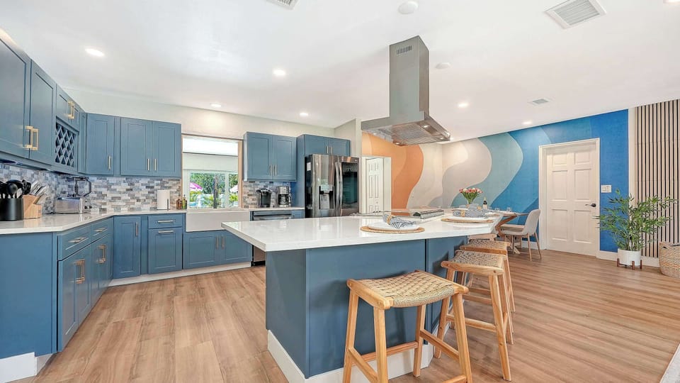 Chef's kitchen with a quartz island, counter seating, and the signature wave wall. Room (and kitchen appliances) to cook for the whole group. All the comforts of home! 