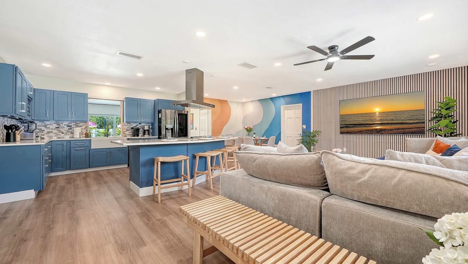 The home flows together so the cook, the couch surfer (watching the 80" TV), and the pool people never feel separated.