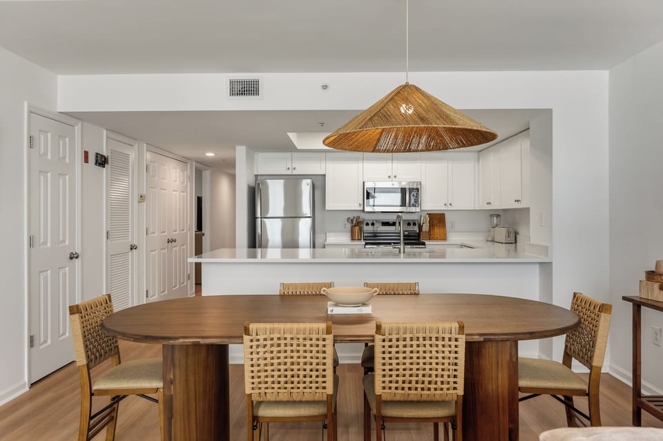 Gather around your stylish dining table beneath the striking woven pendant light, with a fully-equipped kitchen ready for memorable meals together.