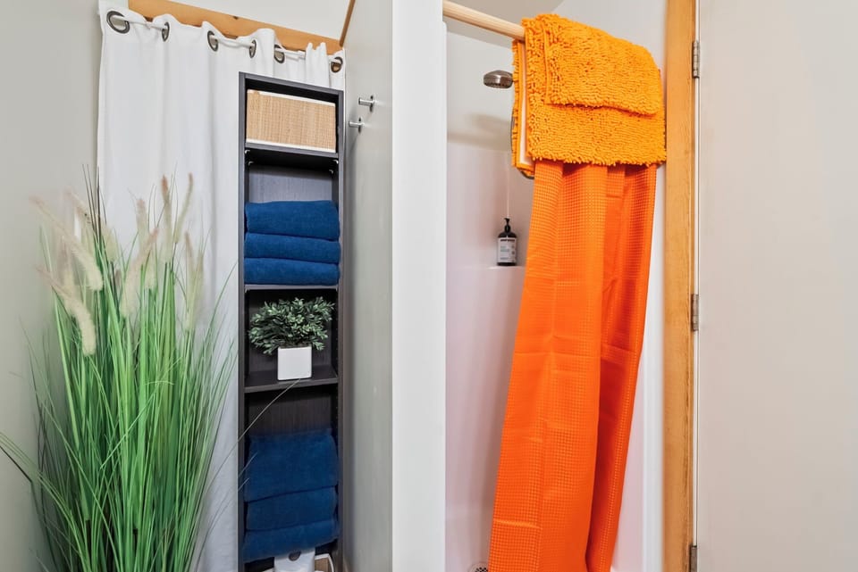 Plush towels await you, adding cozy pops of color to your private bathroom.