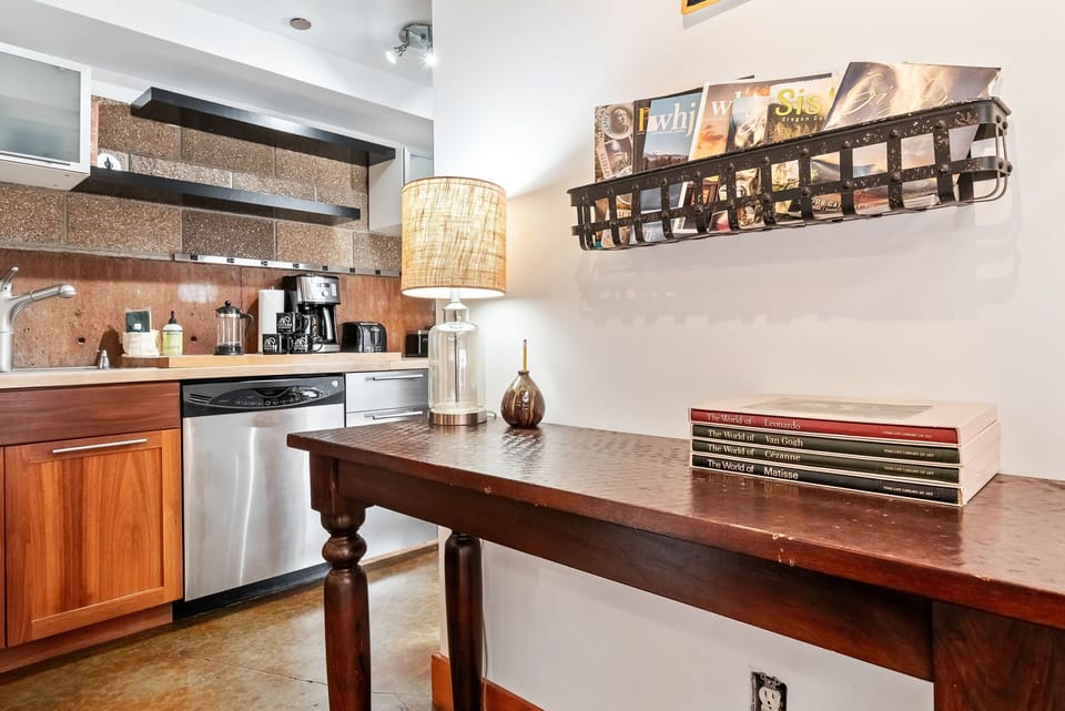 Your charming kitchen awaits with wood accents, modern appliances, and thoughtful touches—including a curated selection of magazines and art books to enjoy during downtime.