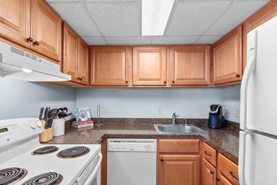 Prepare your favorite beach snacks and meals in this practical kitchen setup, complete with ample upper cabinet storage.