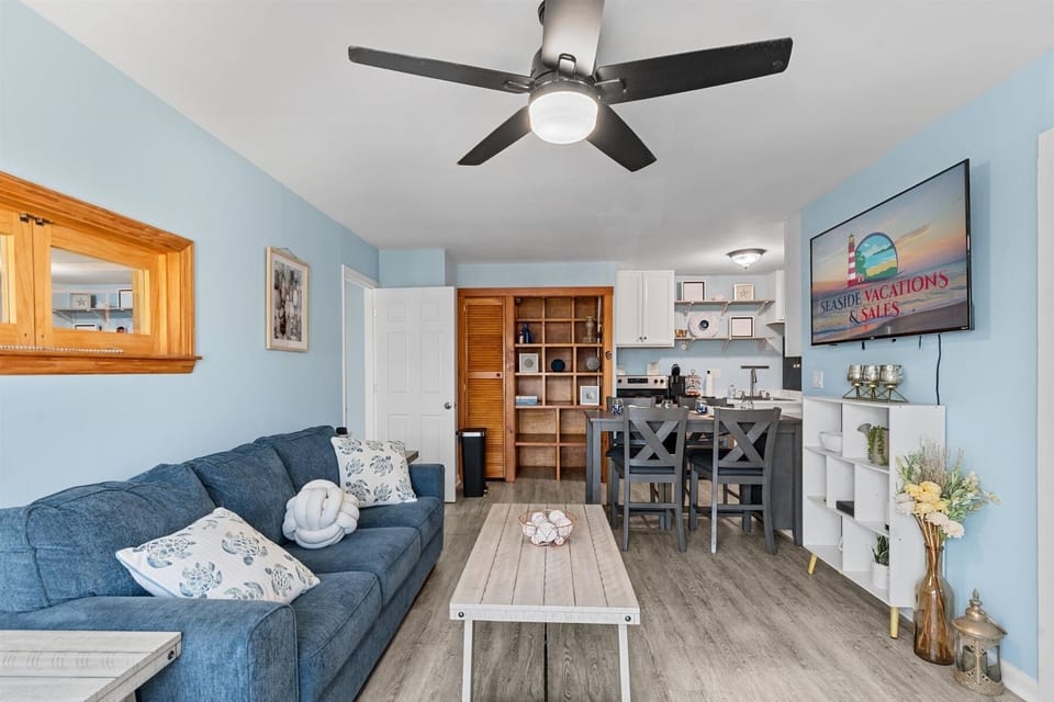 The main living space seamlessly transitions into an open kitchen and breakfast bar area, perfect for entertaining.
