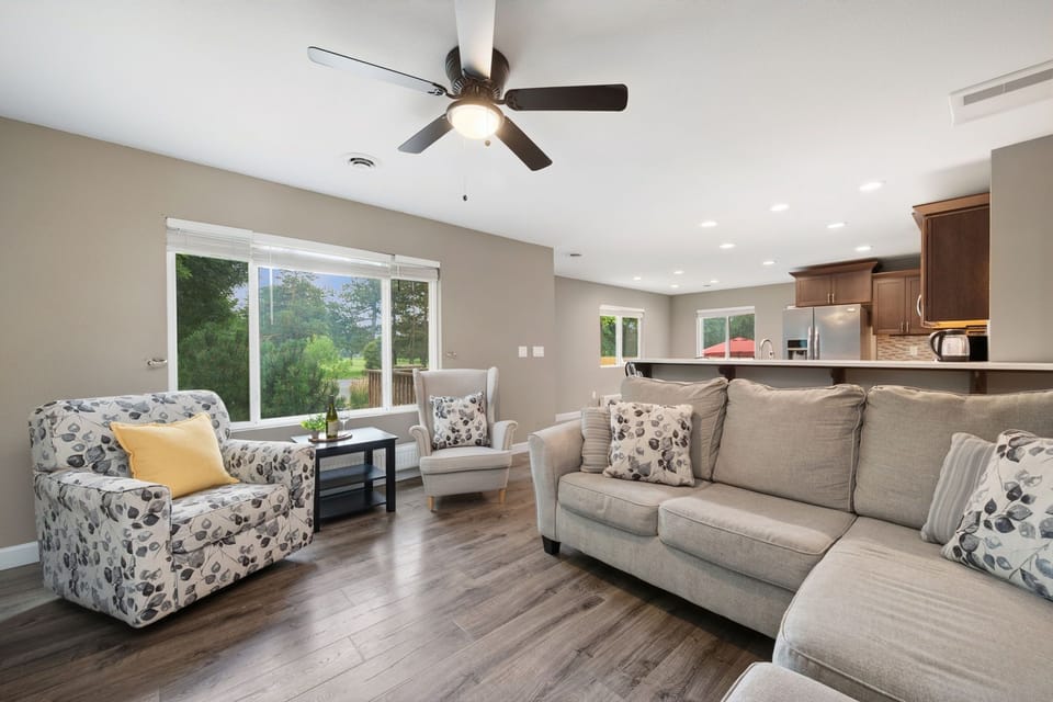 Unwind in your spacious living area with cozy seating, natural light, and an open flow to the fully equipped kitchen—perfect for relaxing or entertaining after a day of adventure.
