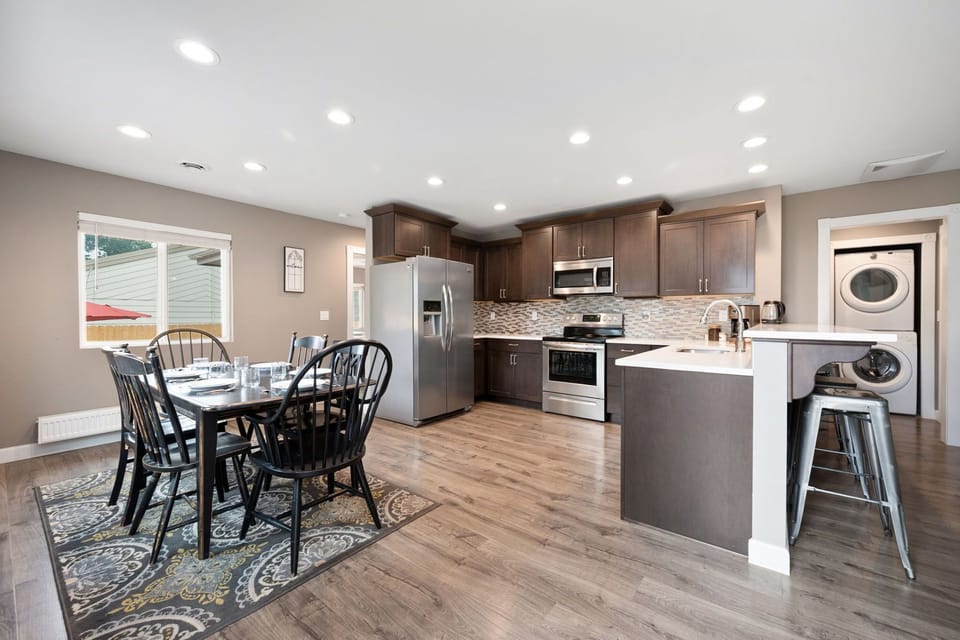 Step into your fully-equipped gourmet kitchen with stainless appliances, granite counters, and a sunny dining area—perfect for gathering with friends and family over home-cooked meals.