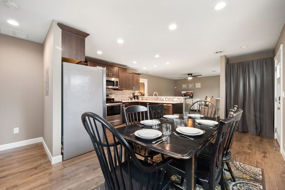 Step into your inviting open-concept space where a welcoming dining table awaits your meals and a fully-equipped kitchen stands ready to help you create memorable moments with loved ones.