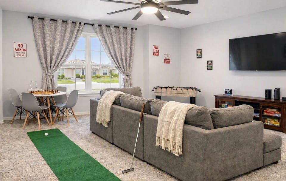 TV, mini golf, foosball 10 in one, table with chairs, sofa, ottoman board games.
