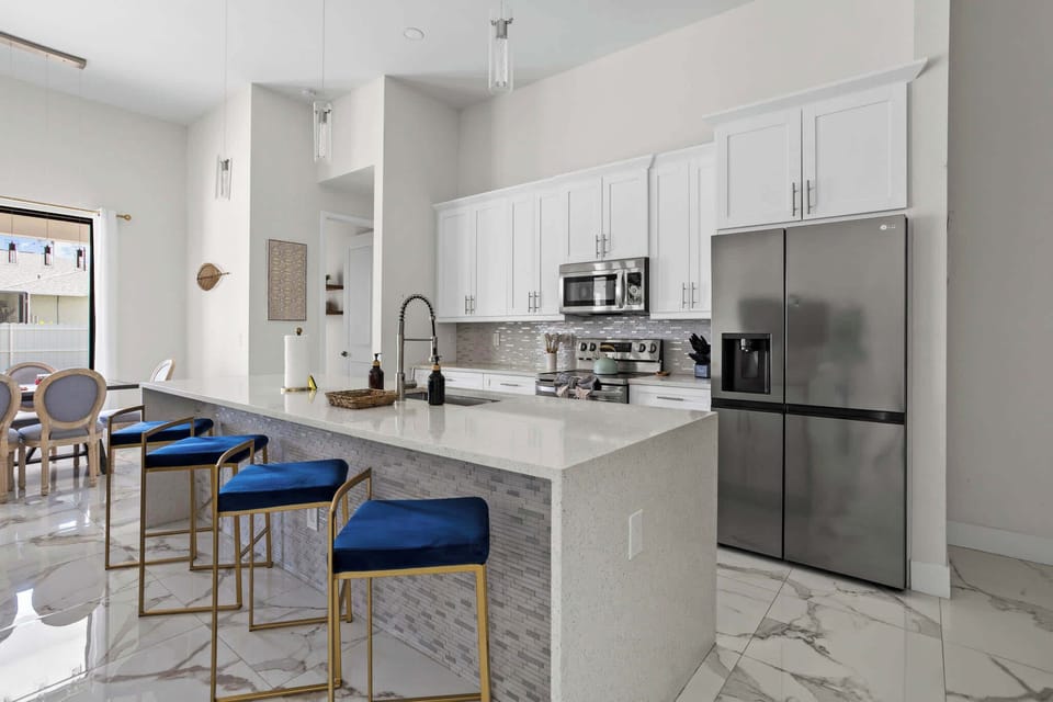 Cook like you mean it. A chef-ready kitchen with stainless steel appliances, quartz counters, and a breakfast bar perfect for morning coffee or happy hour.