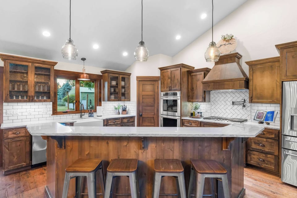 A chef-inspired kitchen with oversized island seating, custom cabinetry, and everything needed for family meals and holiday gatherings.