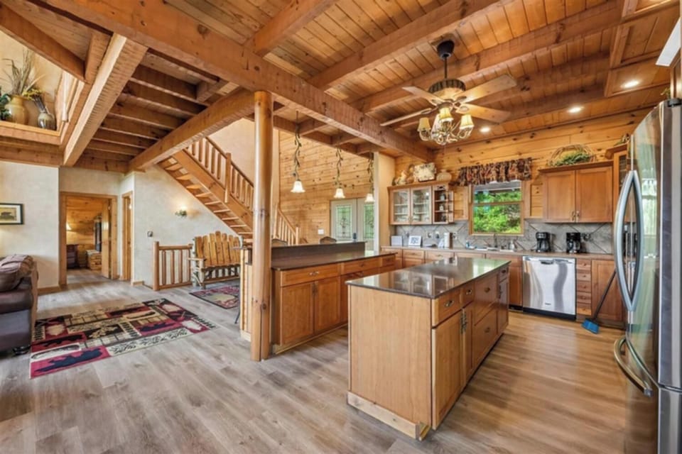 Step into your open-concept cabin retreat with soaring wood ceilings, modern kitchen island, and cozy mountain touches throughout this spacious lodge-style sanctuary.