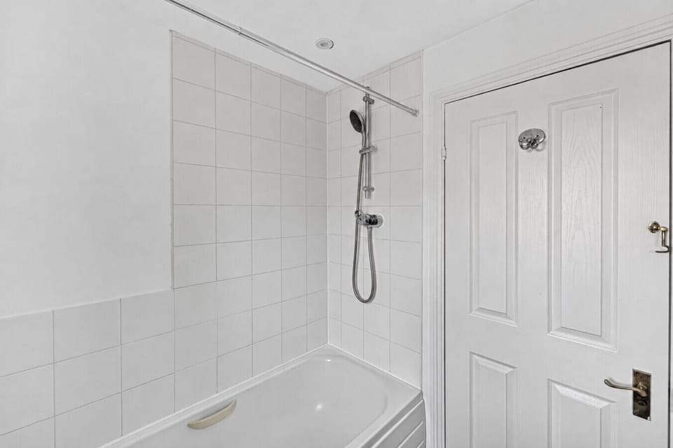 The bathroom features a shower over the bath and complimentary toiletries for your convenience.