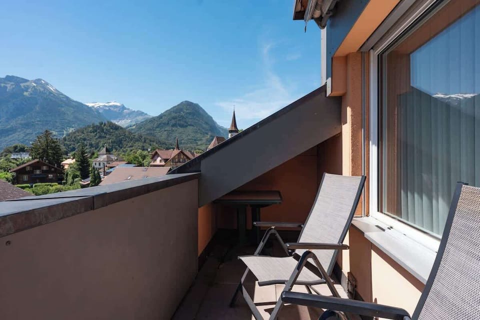 Private balcony with outdoor seating and beautiful views of Interlaken and the surrounding mountains.