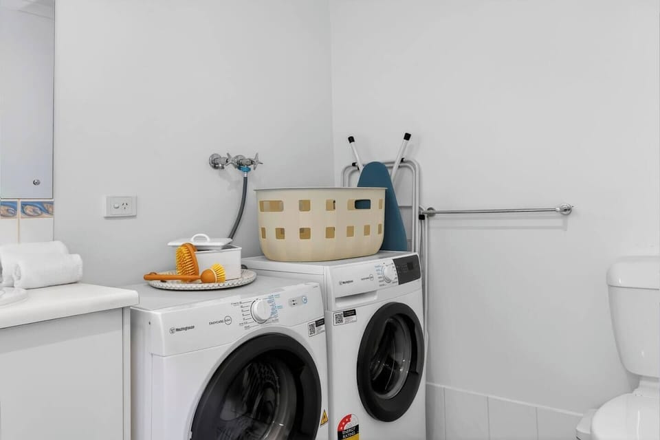 The laundry within the main bathroom makes it easy to refresh beachwear and towels during longer stays on the Fleurieu Peninsula.