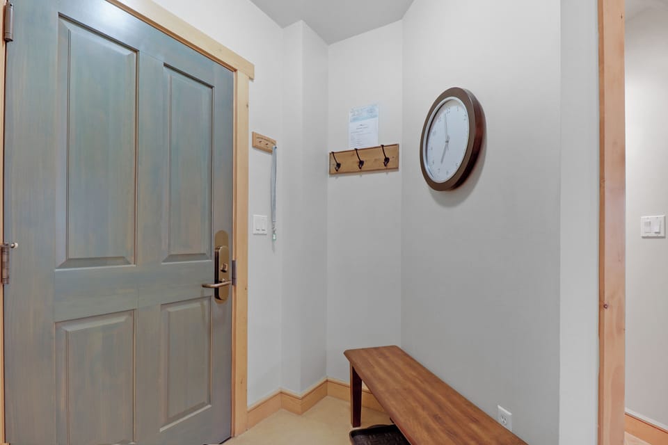 Your peaceful entry awaits, complete with a welcoming bench to settle in, hooks to hang your gear, and a classic clock keeping time on your adventures.