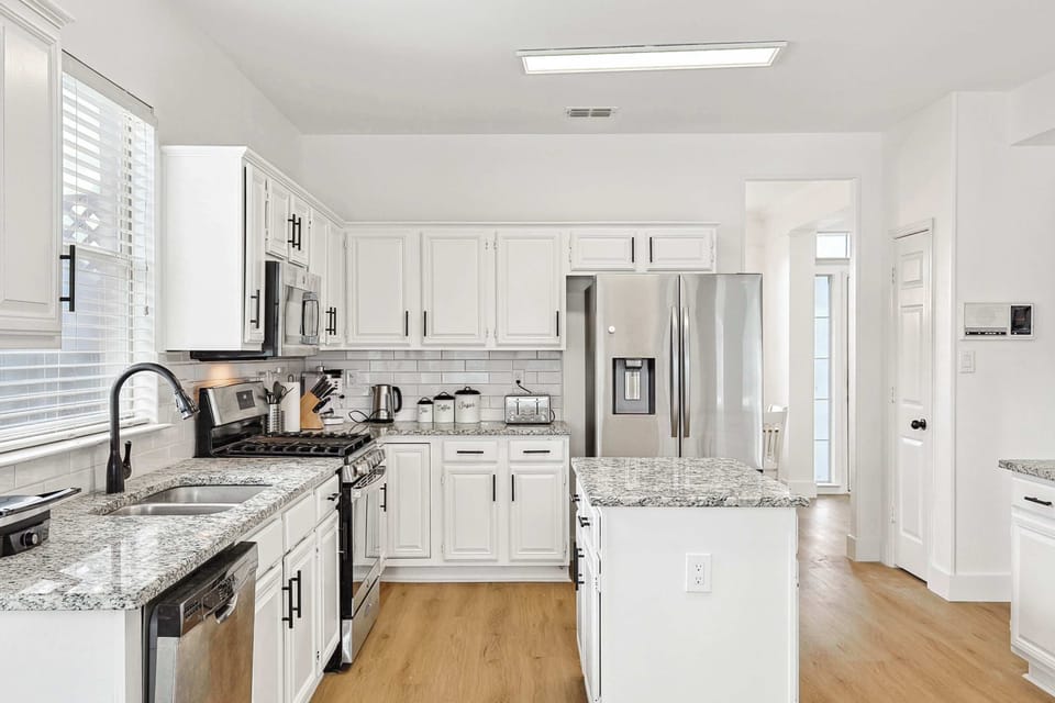 Cook with ease in the fully stocked kitchen, complete with stainless steel appliances and a spacious island.