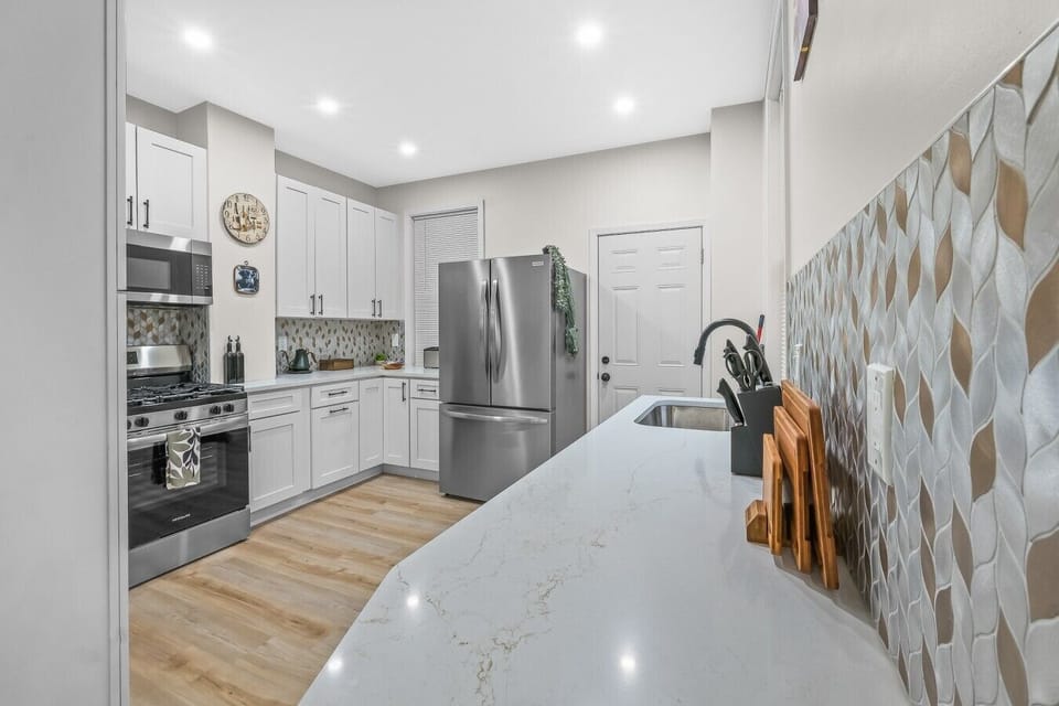 Beautifully renovated kitchen featuring sleek finishes, stainless steel appliances, and ample space to cook and gather.