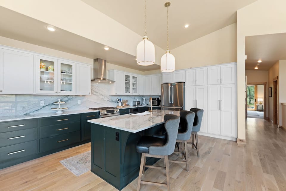 Step into your gourmet kitchen where marble countertops, modern appliances, and a spacious island with seating invite you to create memorable meals together in style and comfort.