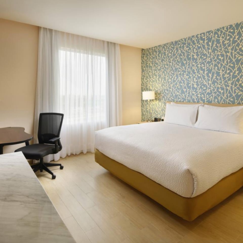 Premium bedding, desk, laptop workspace, iron/ironing board