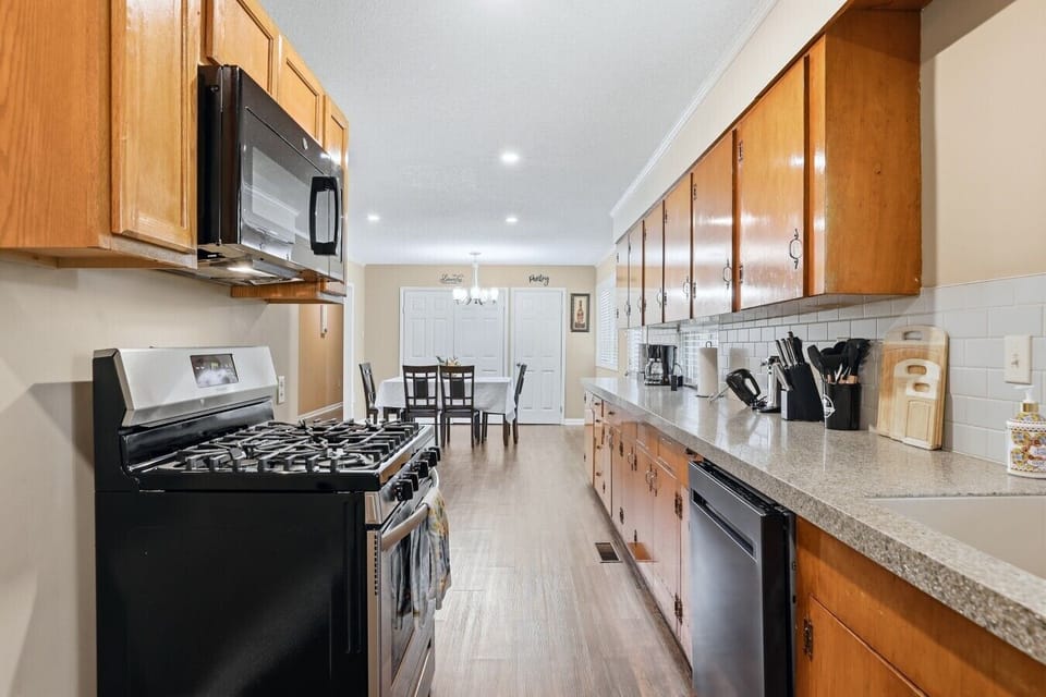 Kitchen | Gas Range & Subway Tile Backsplash | Dining Area Access