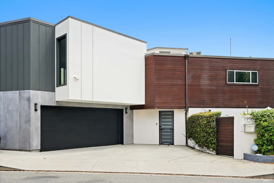 Contemporary facade with clean lines and wood accents 🪵🏡