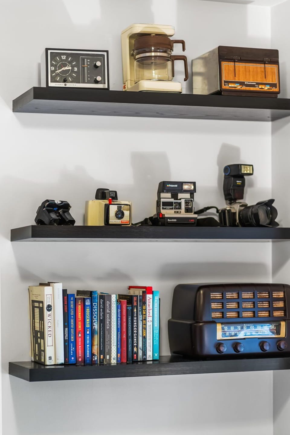 Chic floating shelves with vintage cameras, books, and retro decor