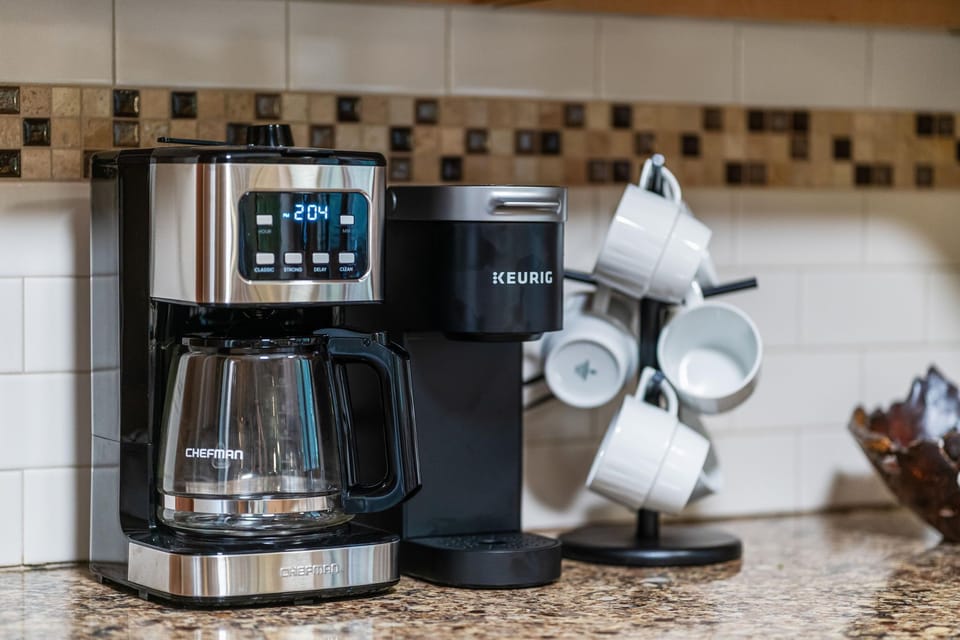 Convenient coffee station with drip maker, Keurig, and mugs ready