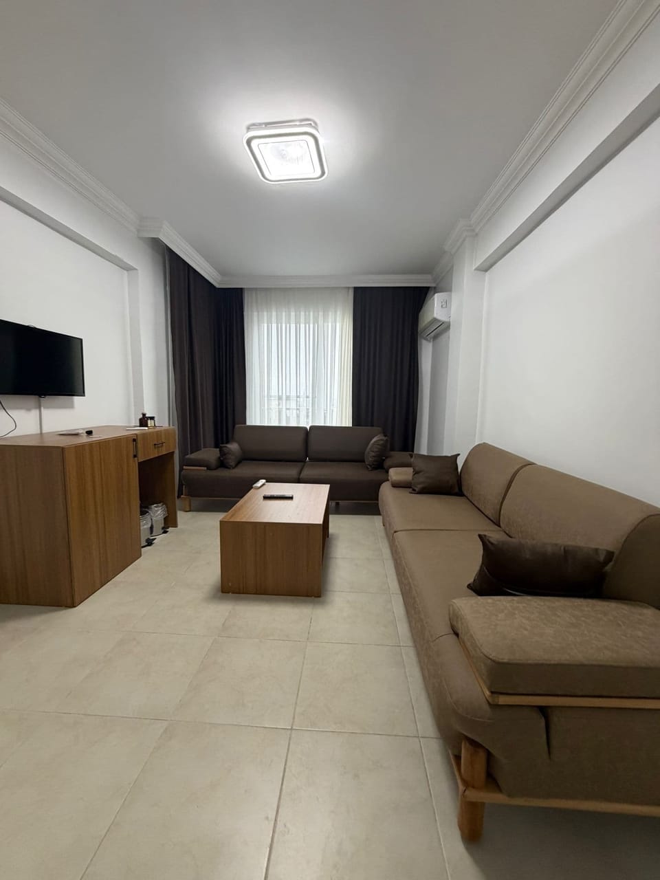 Basic Quadruple Room, Sea View | Living area | 55-inch TV with satellite channels