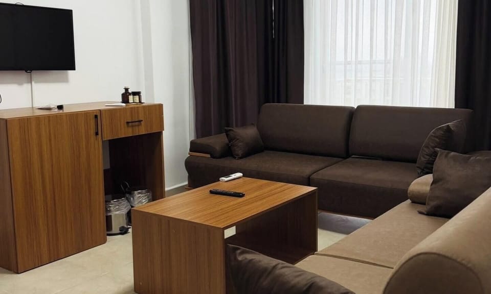 Basic Quadruple Room, Sea View | Living area | 55-inch TV with satellite channels