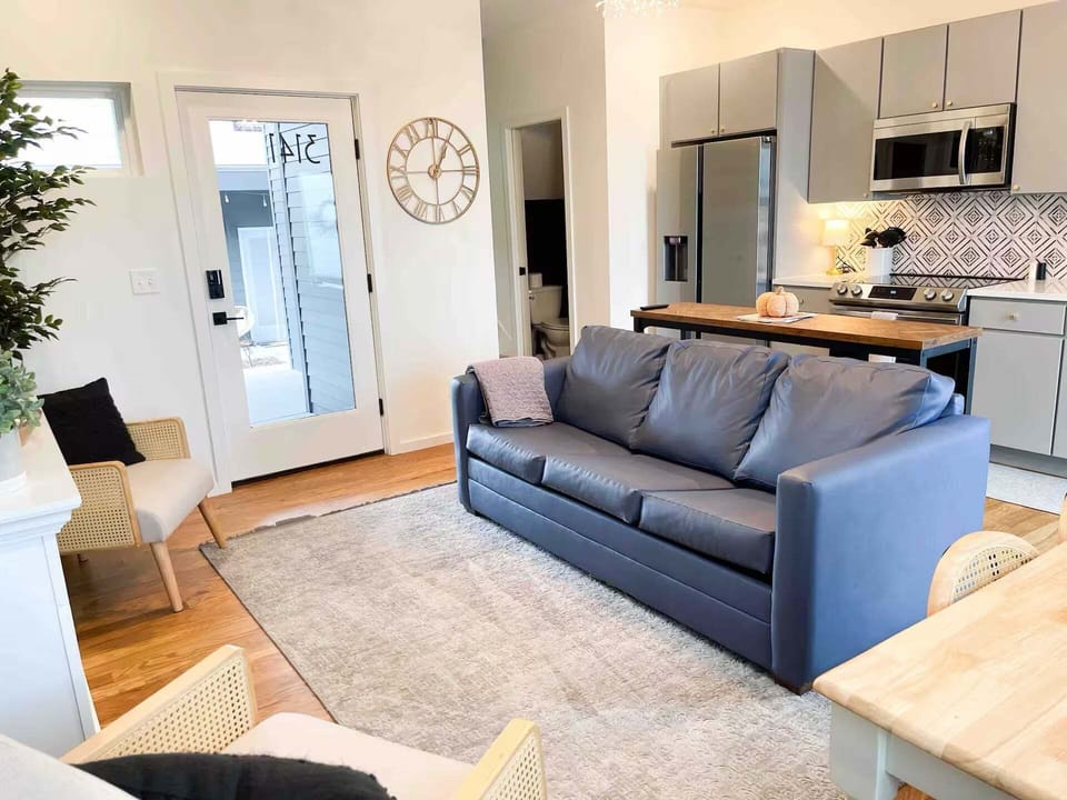 Open concept living area with dining bar and comfy furnishings for perfect TV viewing + sleeper sofa (sleeps 2)