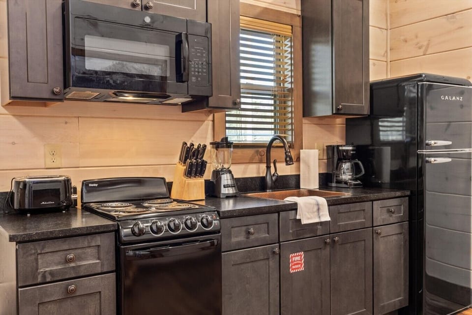 Full kitchen with stove, refrigerator, drip coffee maker