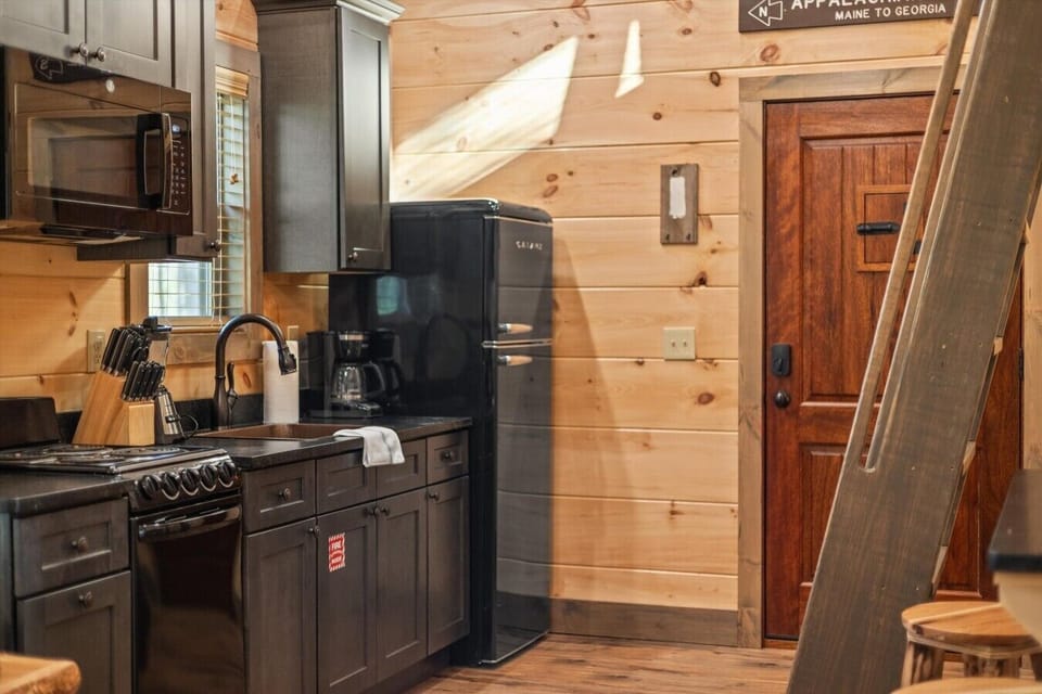 Full kitchen with stove, refrigerator, drip coffee maker