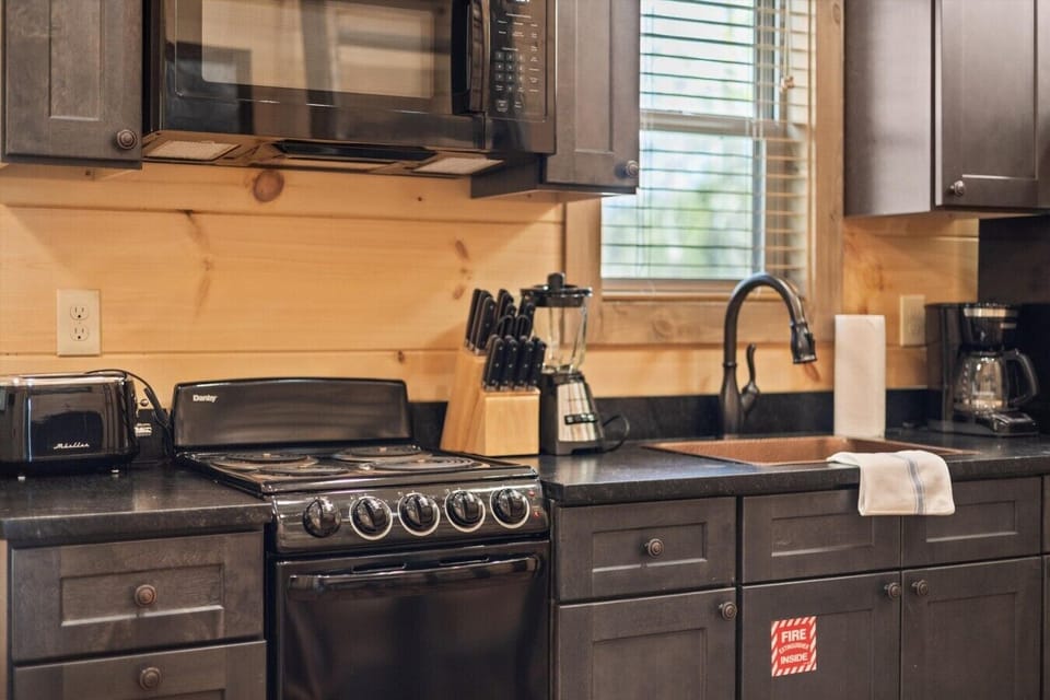 Full kitchen with stove, refrigerator, drip coffee maker