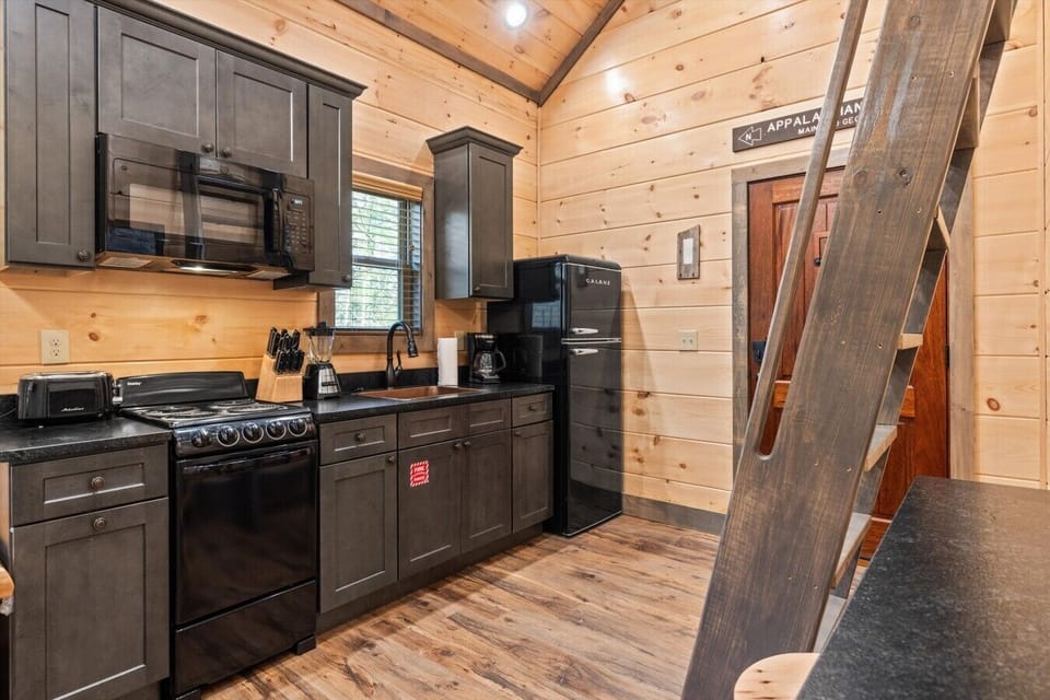 Full kitchen with stove, refrigerator, drip coffee maker