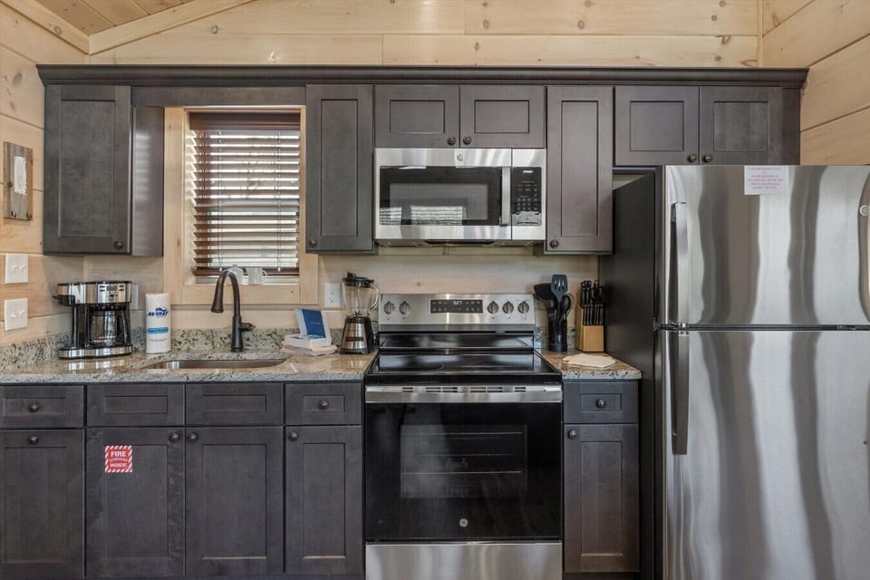 Full kitchen with stove, refrigerator, drip coffee maker