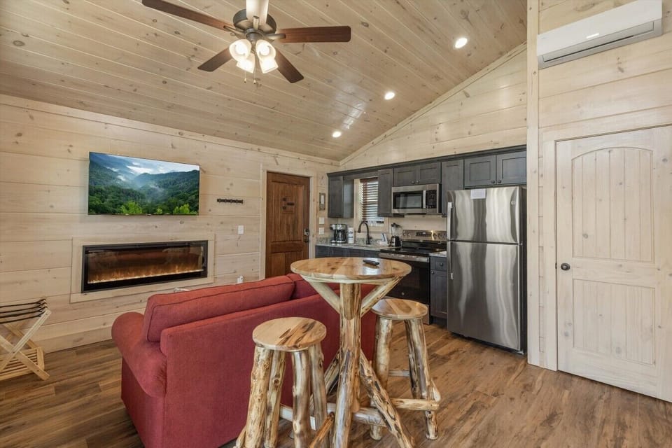 Living space with full kitchen, smart tv, dining, electric fireplace