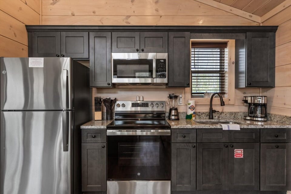 Full kitchen with stove, refrigerator, drip coffee maker